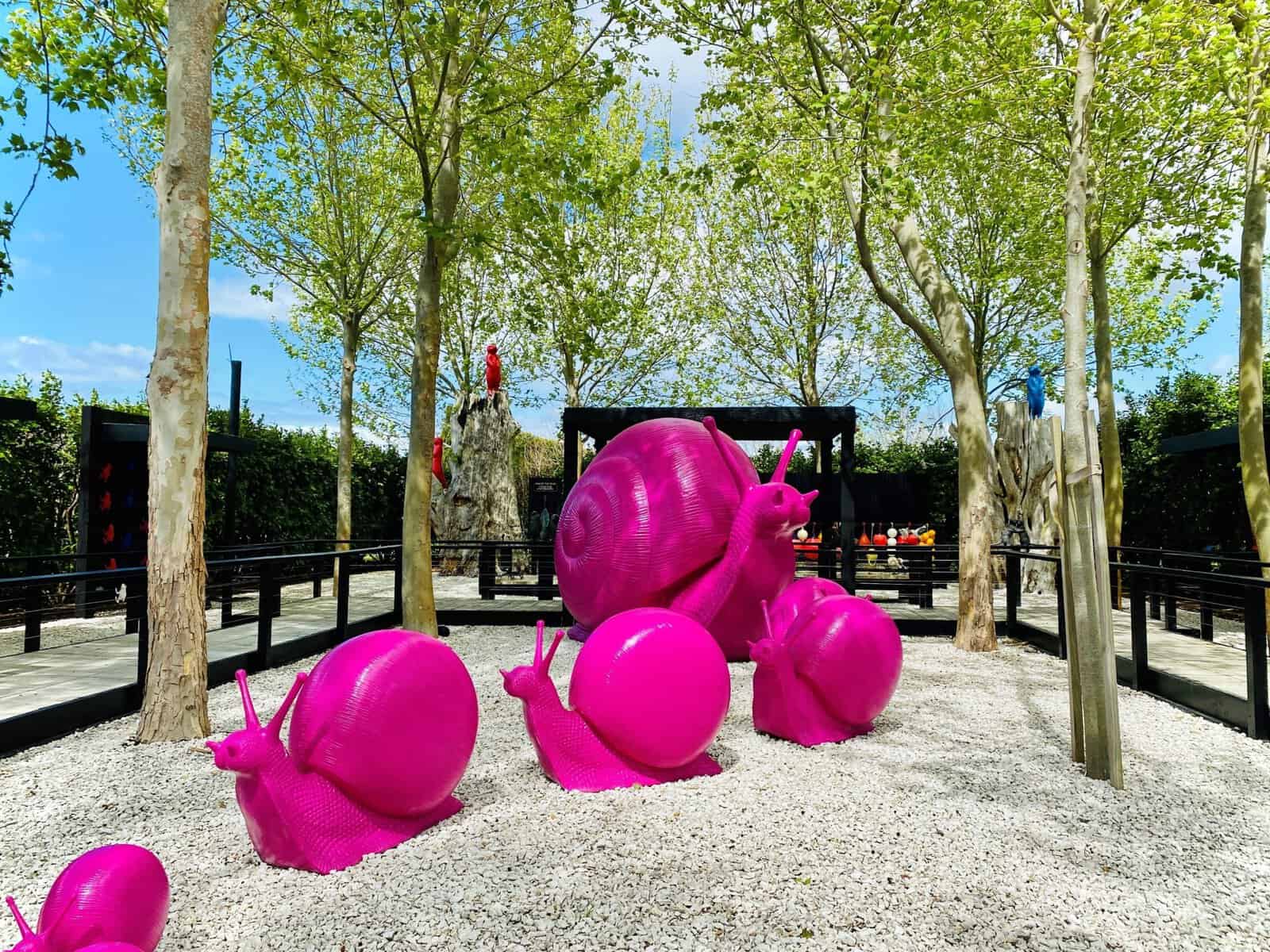 Vivid pink snail sculptures at Sculptureum, a popular art and sculpture park in New Zealand.