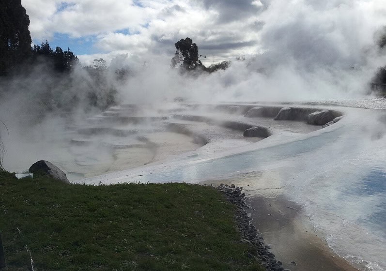 Steaming hot springs cascading down the mineral-rich, silica-formed steps of the Wairakei Terraces thermal pools near Taupō.