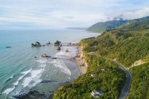 View of the rugged west coast of new zealand showing surf and rocks.