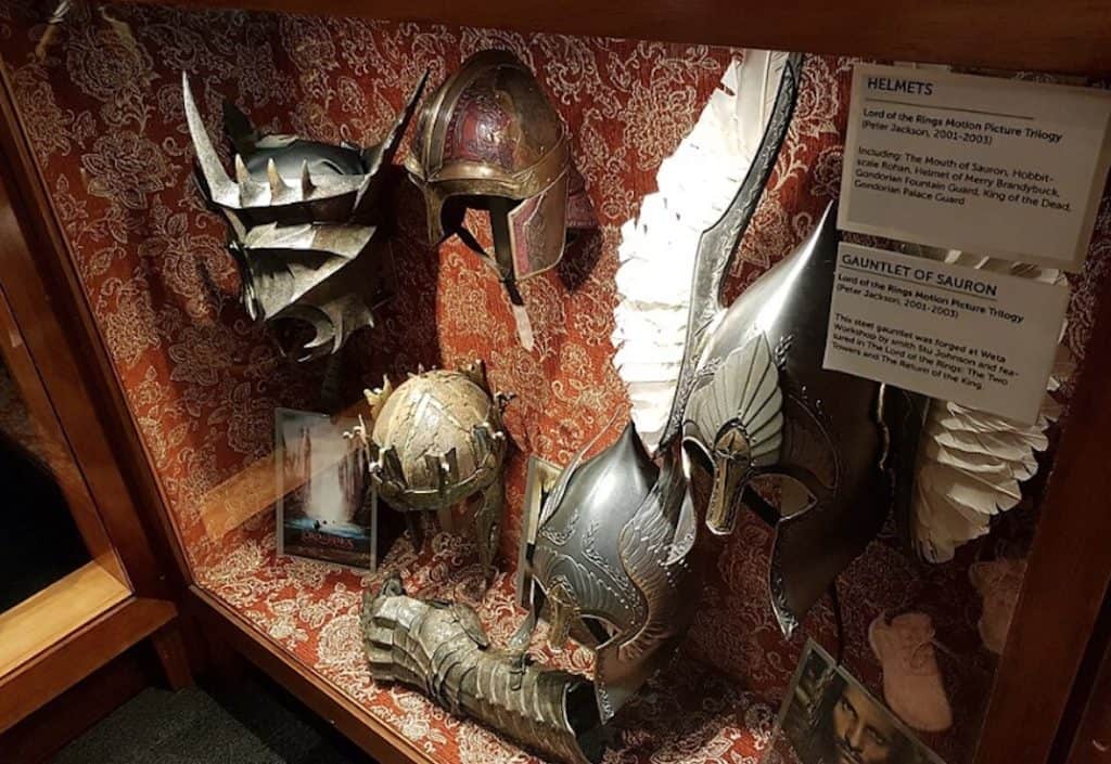 A collection of detailed movie masks, props, and fantasy headwear on display inside the Wētā Workshop experience in Wellington.
