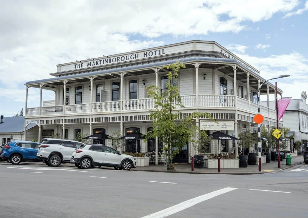 The historic two-story facade and main entrance of the Martinborough Hotel facing the village square.